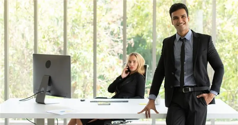 Man and woman standing by window.png